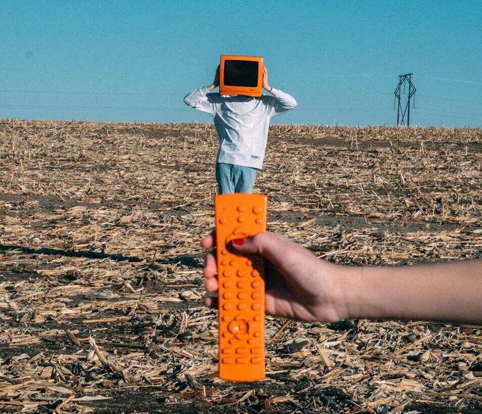 person wearing TV helmet with remote